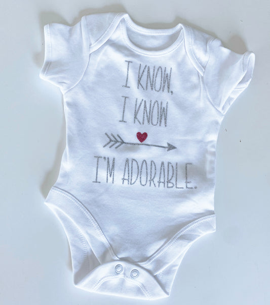 Baby onesie slogan 'I know, I know, I'm adorable'